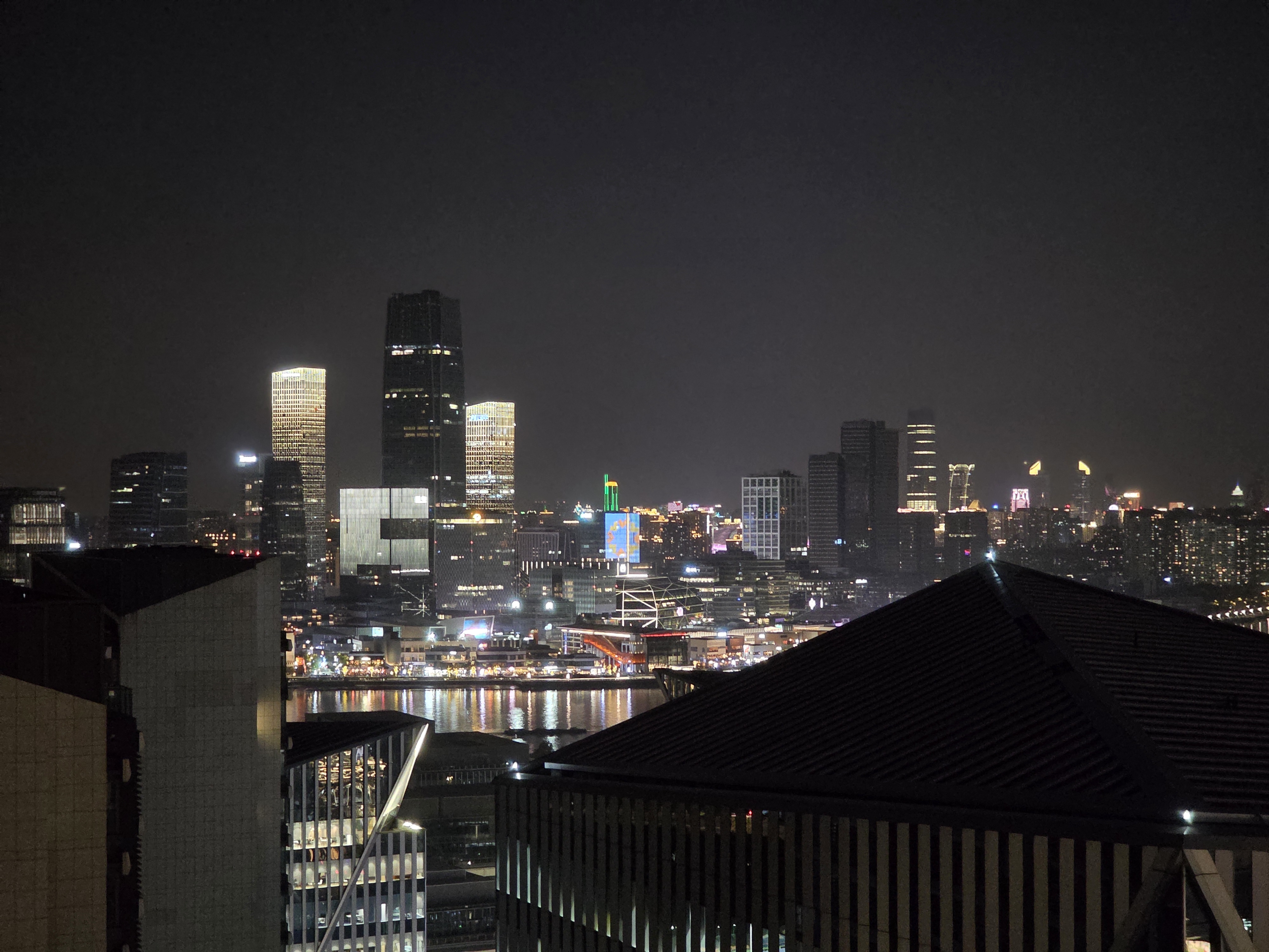 Shanghai's skyline reflected across the river at night